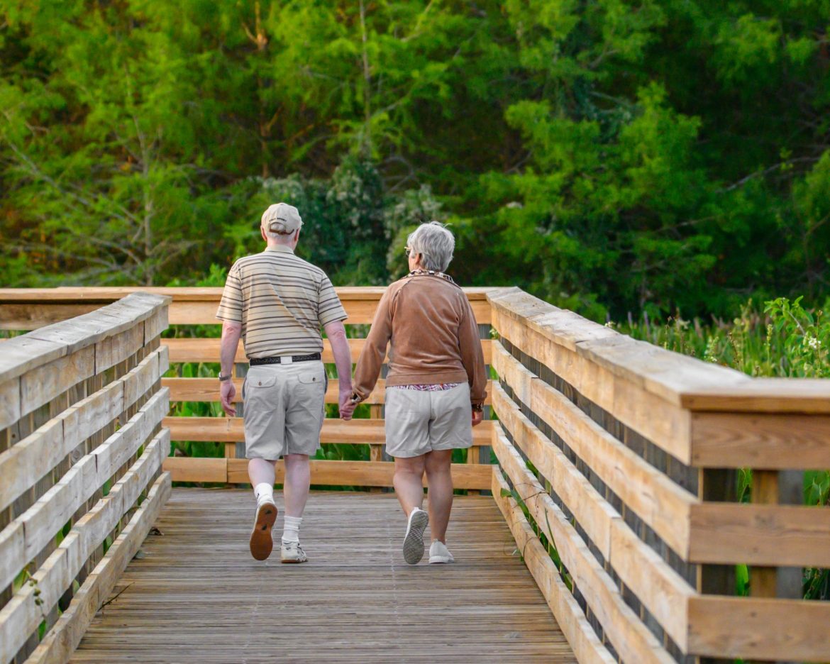 Senior couple walking on a boardwalk
