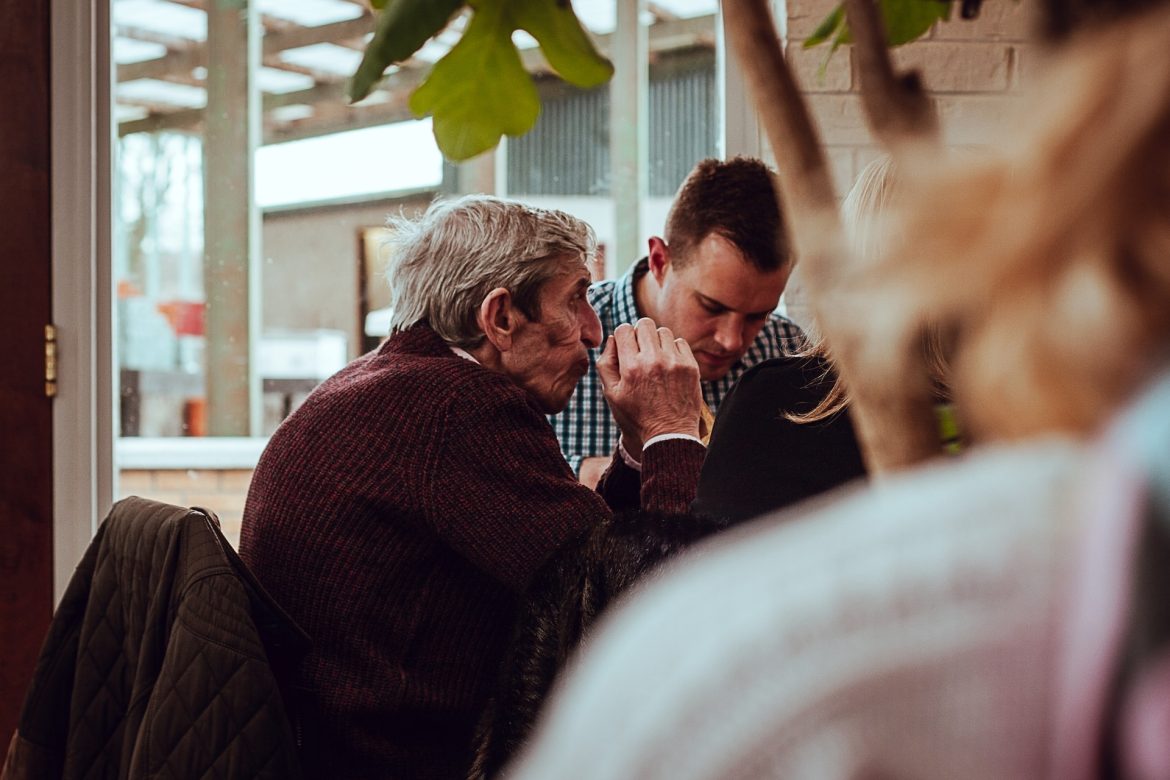 Elderly person and caregiver sharing a moment, showcasing support and companionship.