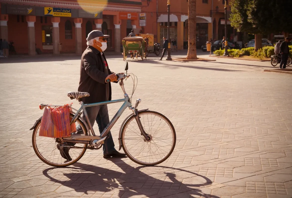 Public Transportation Needs to Be More Senior-Friendly Man Leading Biycle in Town